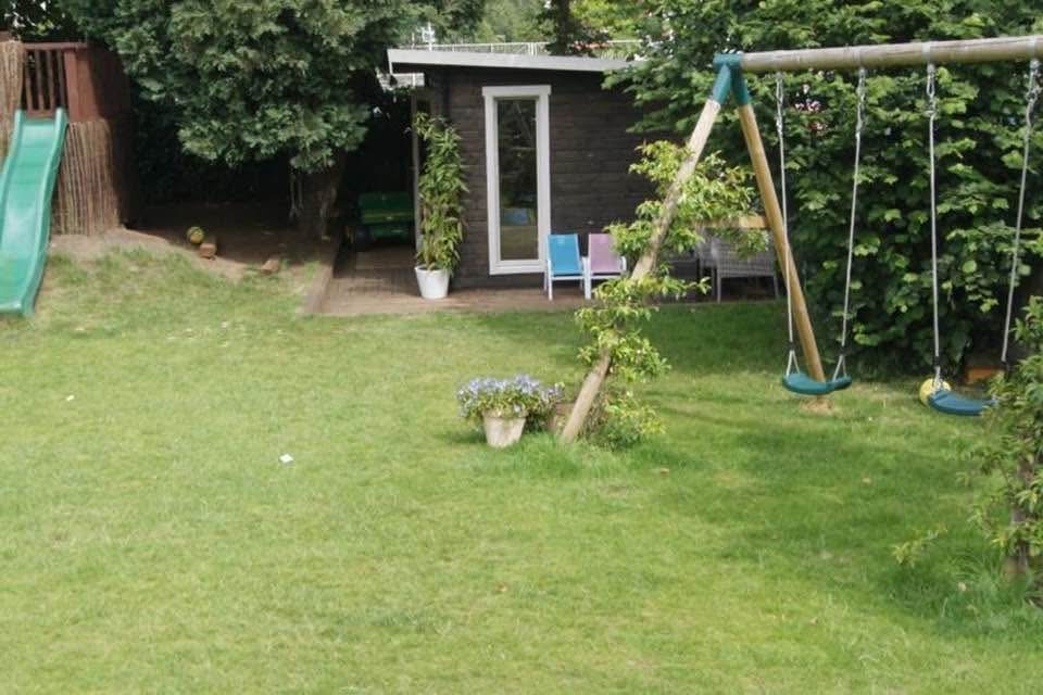 Garden before landscaping with lawn and play equipment