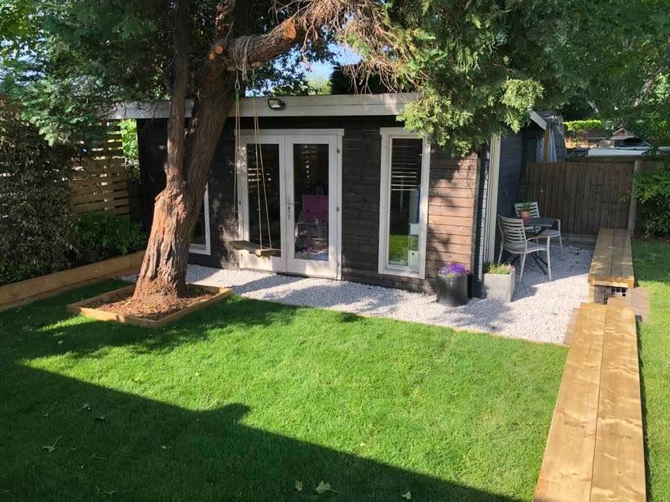 Finished summer house garden with turf and timber seating